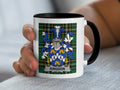 White mug with black rim featuring Kingdon family crest on plaid background.