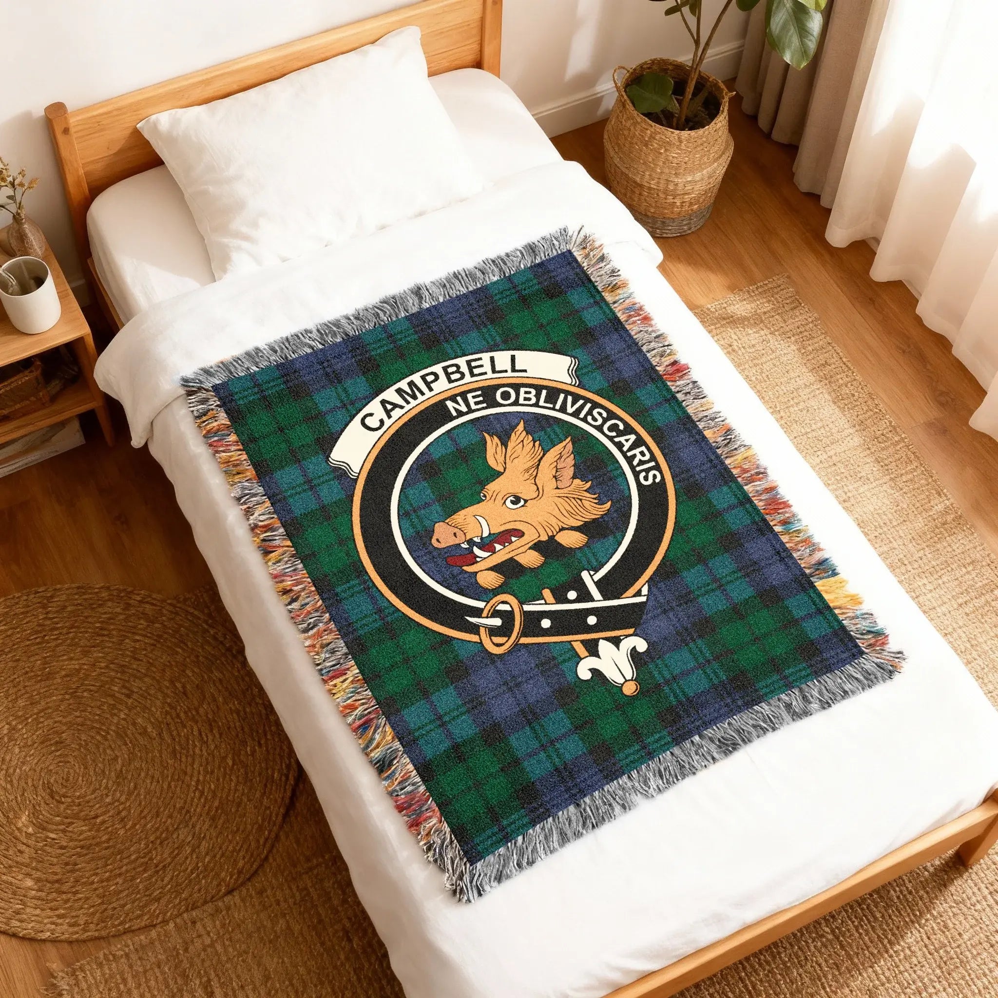 Campbell Ne Obliviscaris woven blanket folded — dark green and black tartan with crest panel