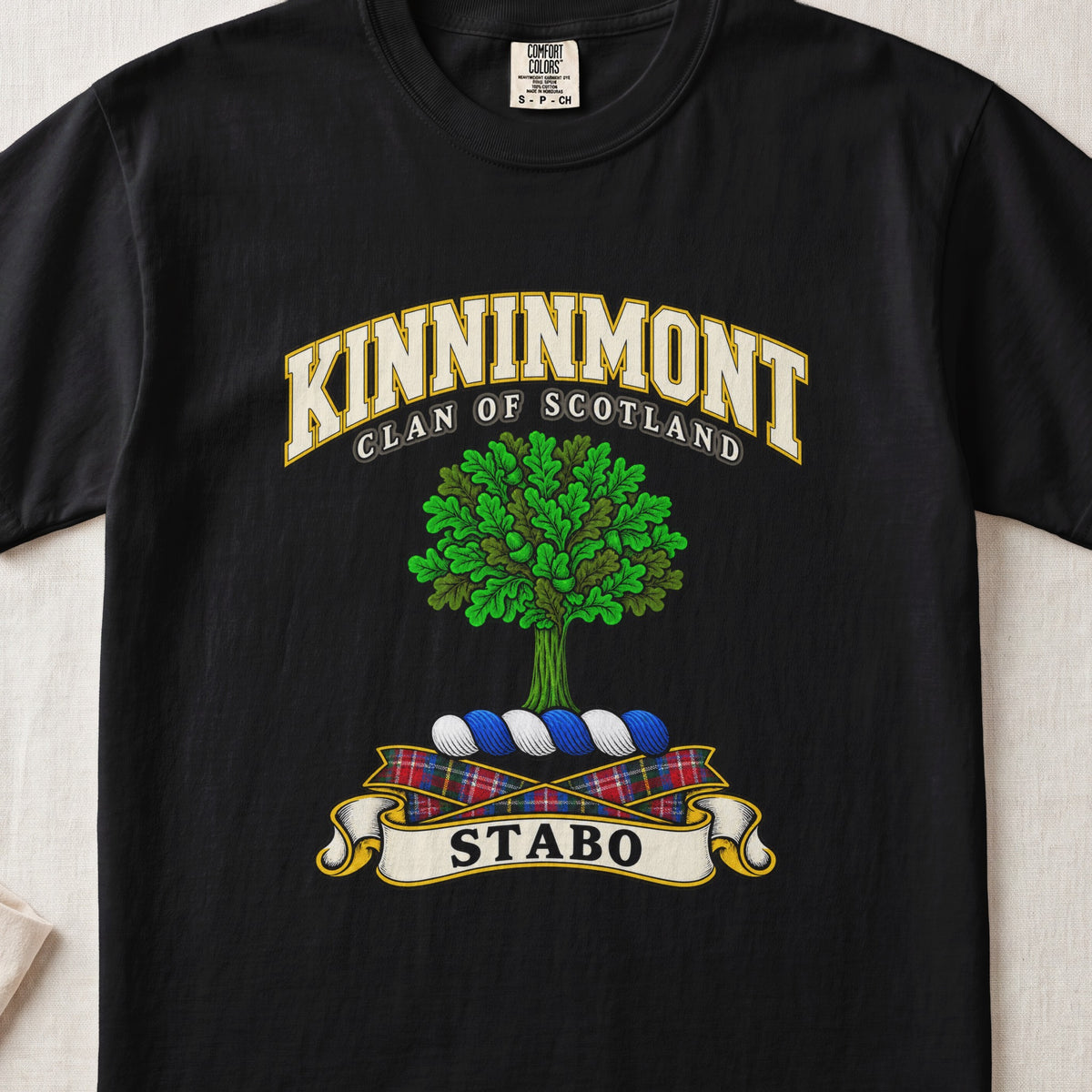Kinninmont Scottish clan T-shirt in Black, front view with a green tree and motto banner.