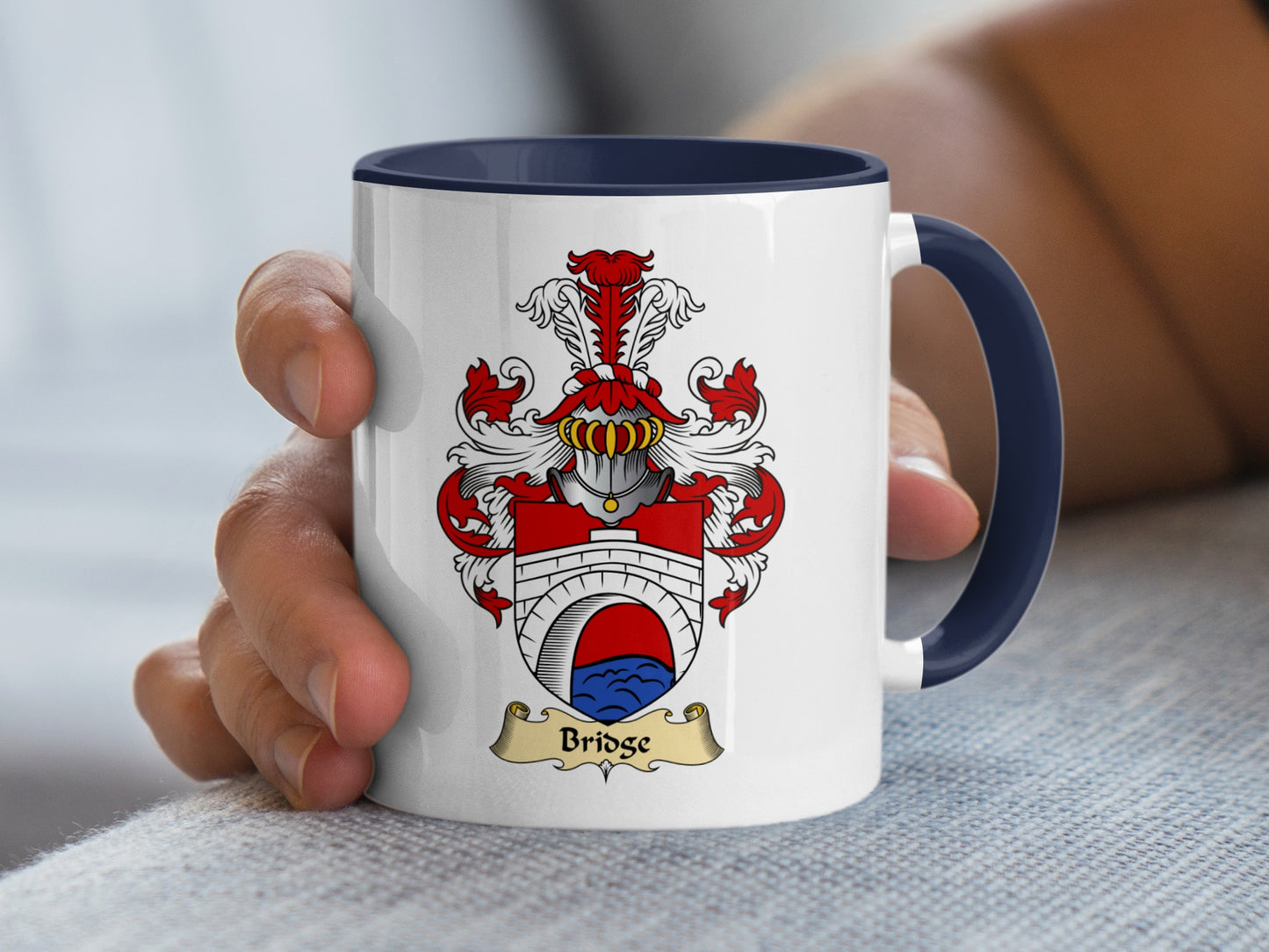 White mug with blue handle and Bridge family crest.