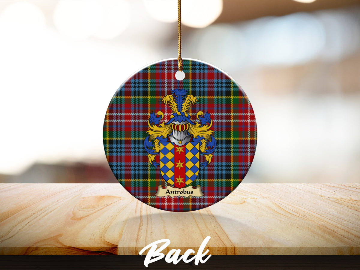 Round Antrobus Scottish clan ornament with family crest on a Caledonia tartan background