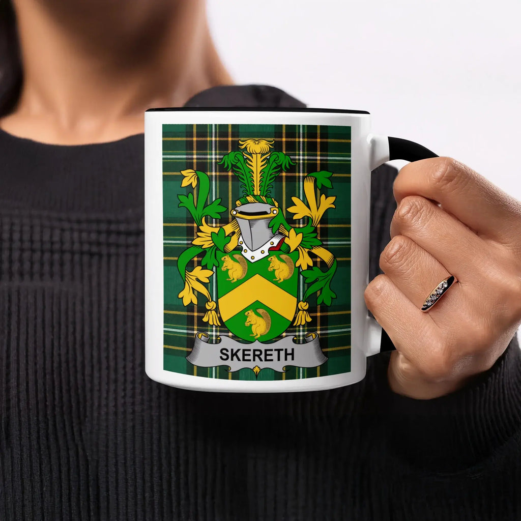 White mug with black handle featuring green and yellow plaid and the crest "SKERETH".
