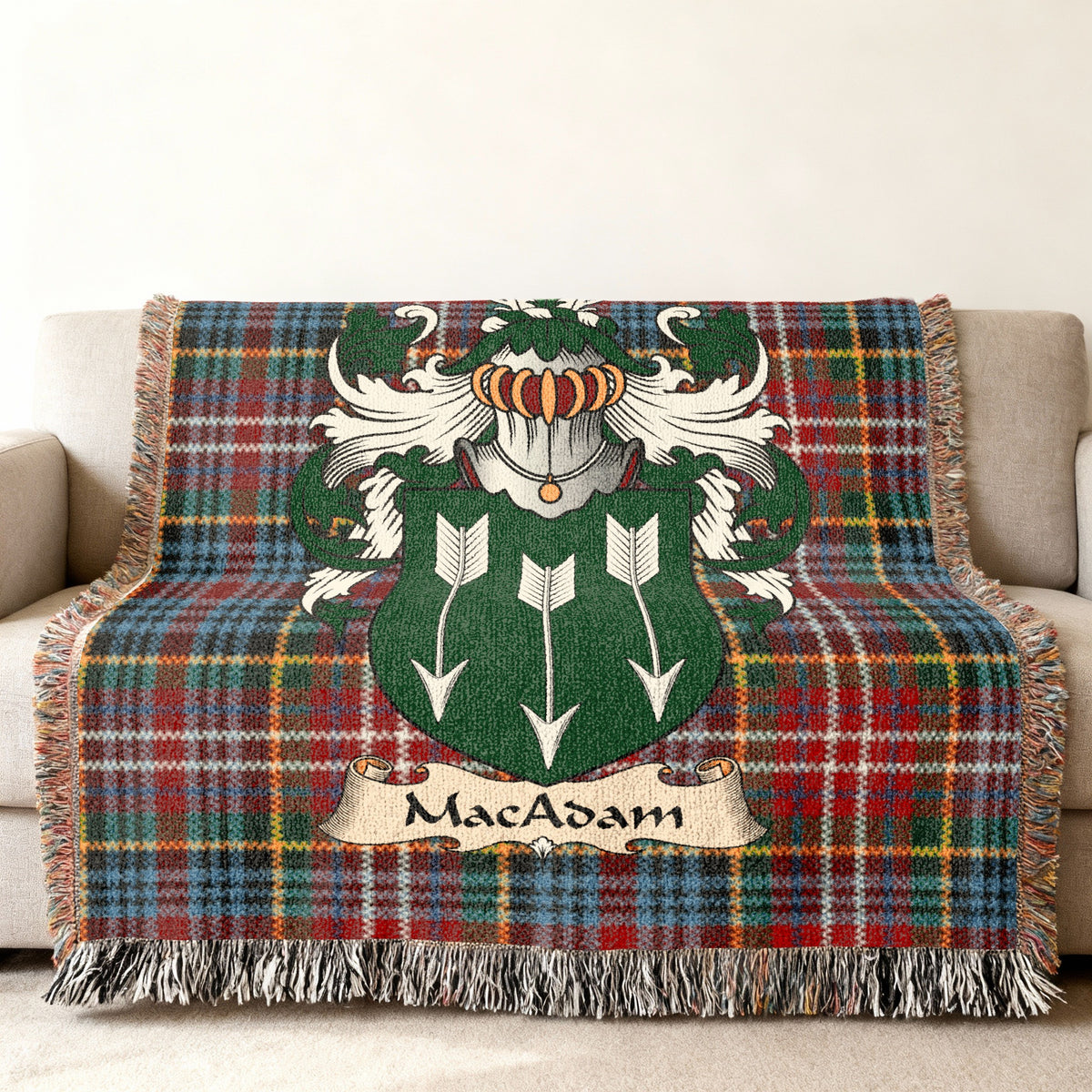 MacAdam family crest emblem on a Caledonia tartan woven blanket