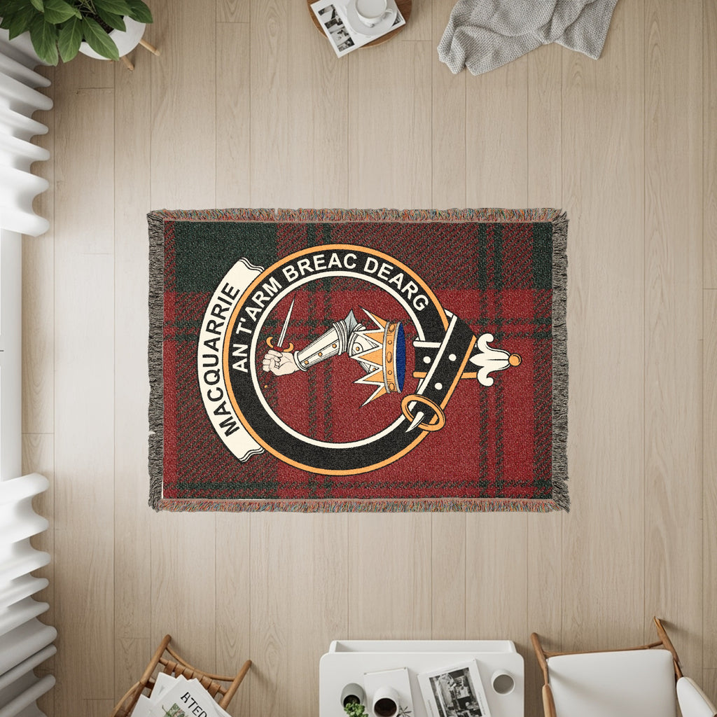 MacQuarrie woven blanket displayed on a wall, featuring the crest badge and tartan background