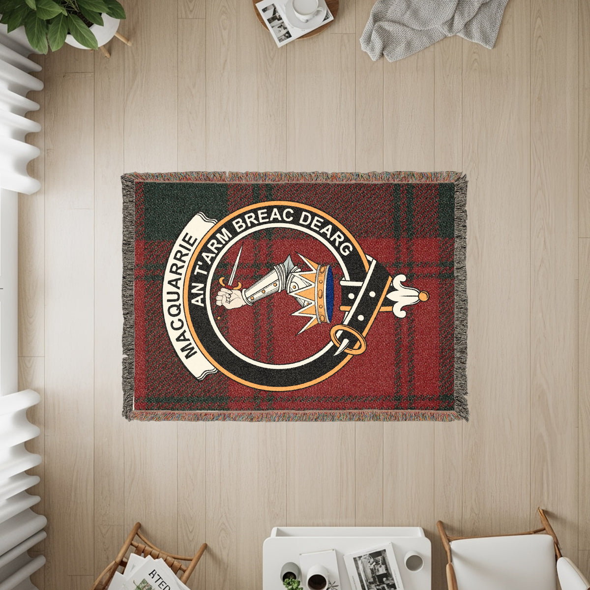 MacQuarrie woven blanket displayed on a wall, featuring the crest badge and tartan background