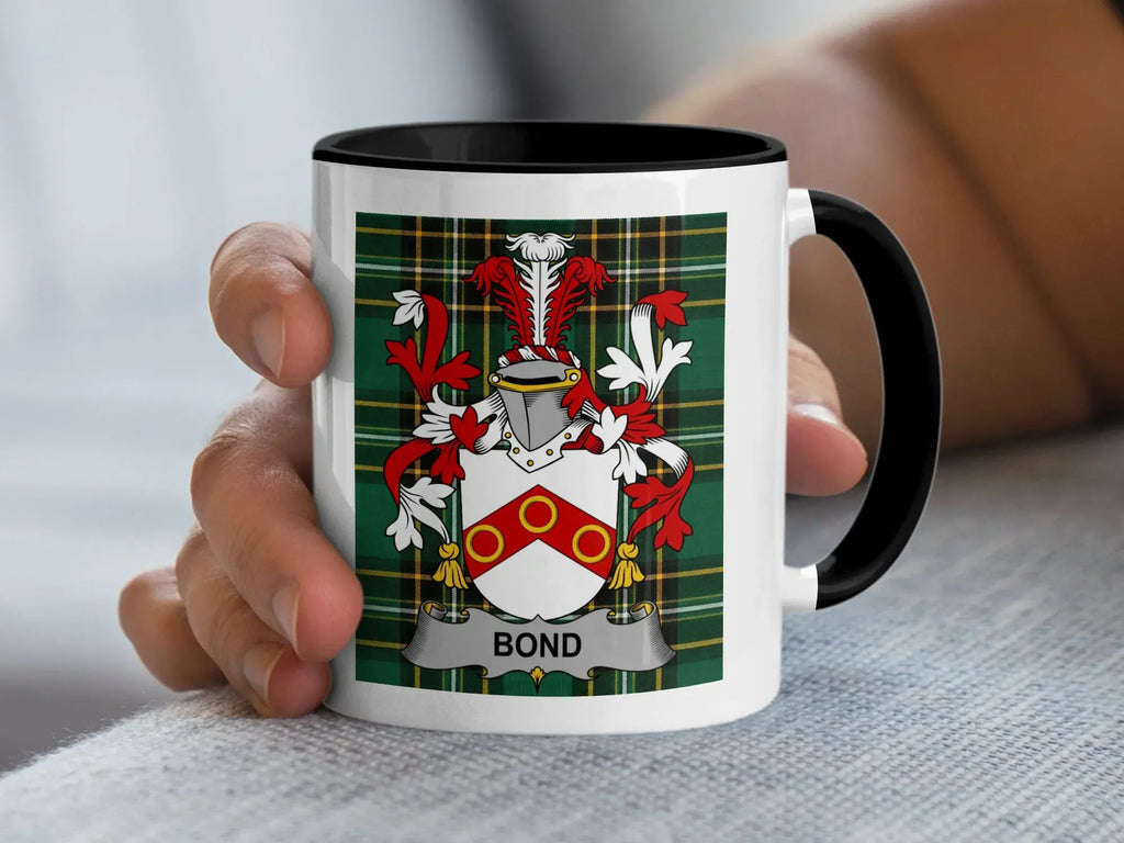 White mug with black rim featuring the Bond family crest on a tartan background.