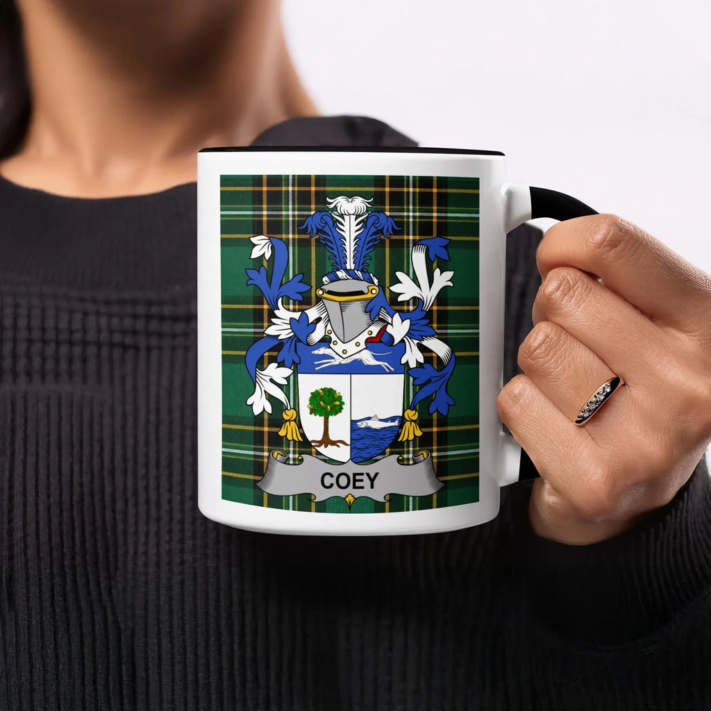 Mug with Coey family crest on tartan background.