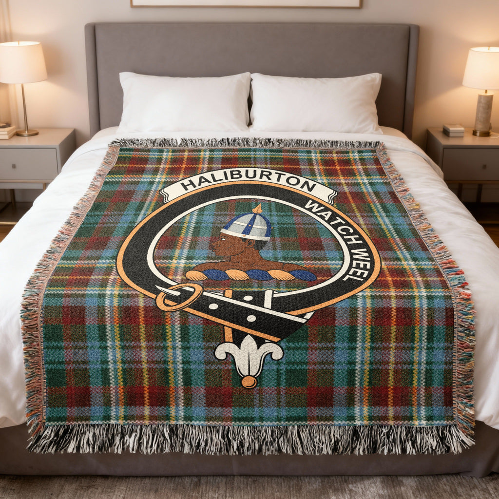 Haliburton woven blanket displayed on a bed, with a helmeted head on a green, red, blue and yellow tartan background