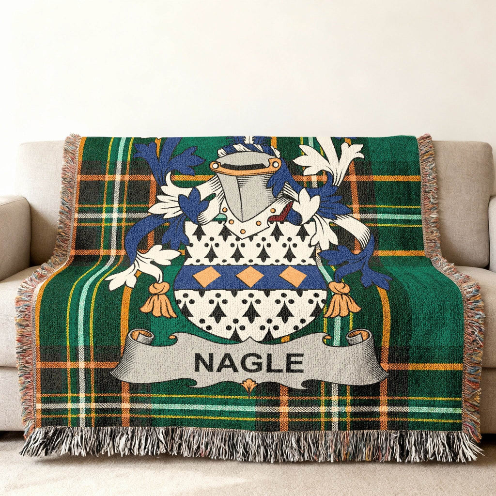 Nagle family crest on green tartan plaid blanket draped on a sofa.