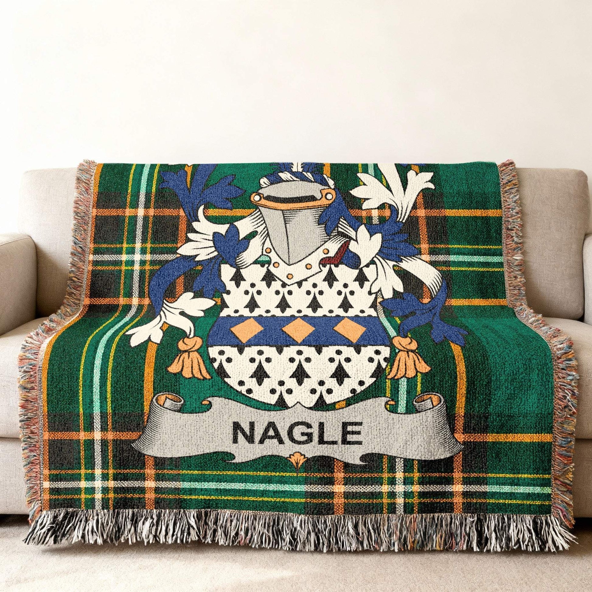 Nagle family crest on green tartan plaid blanket draped on a sofa.