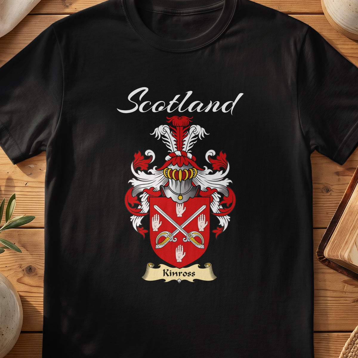 Black Kinross Scottish T-shirt featuring crossed blades and white hand motifs on red