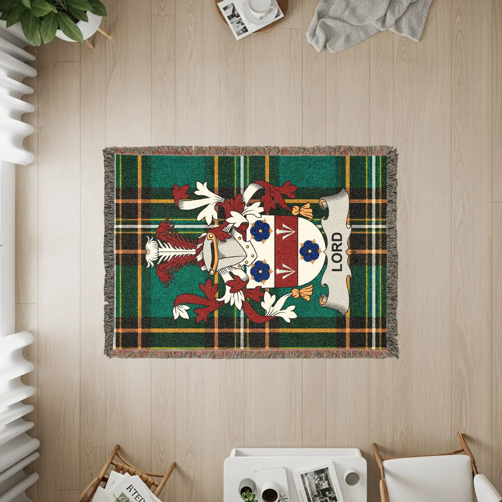 Tapestry blanket featuring the Lord family crest on a green tartan background.