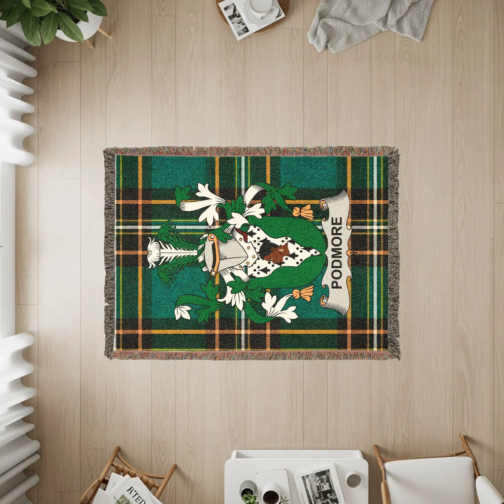 Woven blanket with green plaid and the PODMORE clan crest.