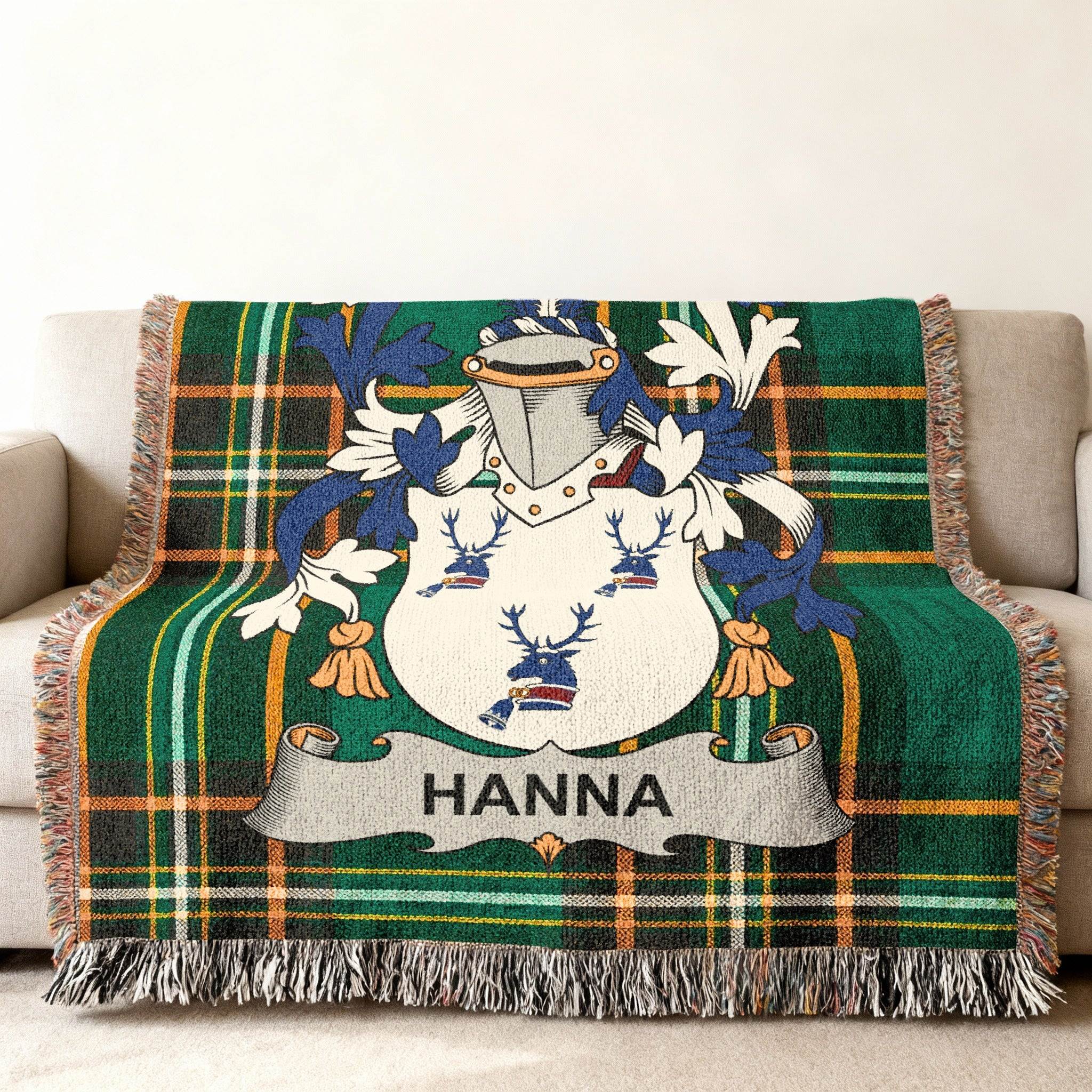 Green plaid throw blanket featuring a coat of arms with the name HANNA.
