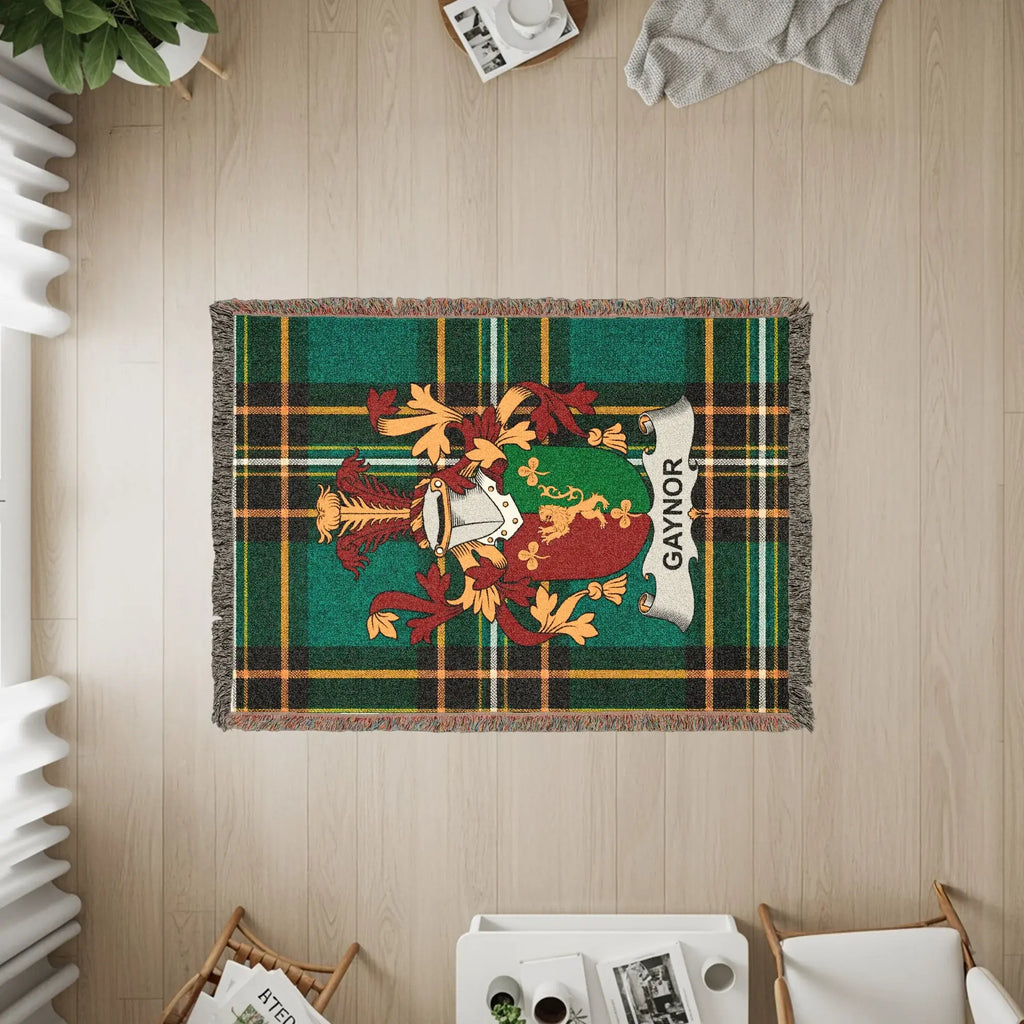 Green and gold plaid woven blanket featuring the Gaynor family crest.