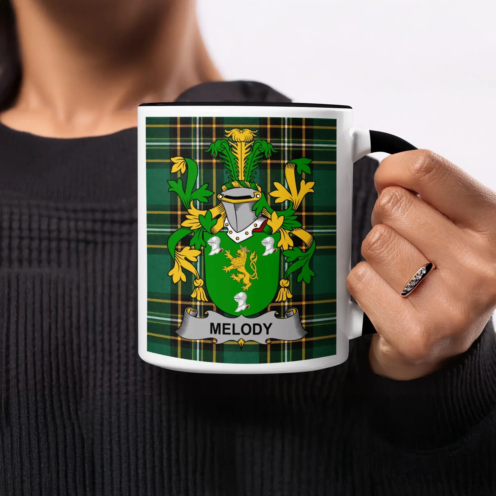 Mug with the Melody family crest on a green plaid background.