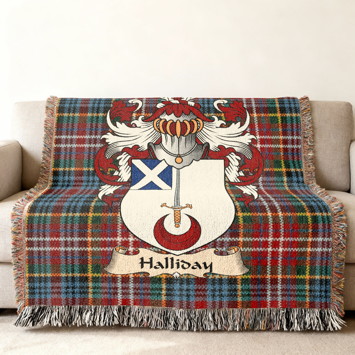 Halliday family crest emblem on a Caledonia tartan woven blanket