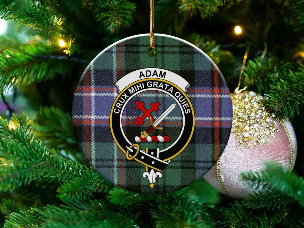Adam ceramic ornament with crest and motto on a tartan-pattern background