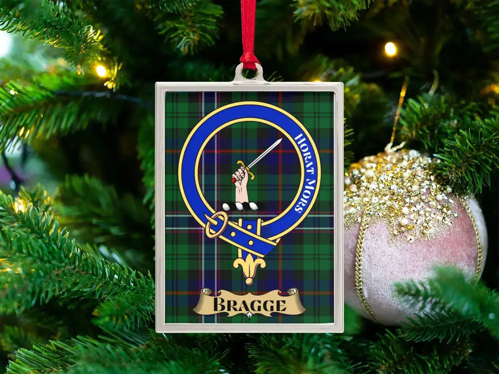 Bragge clan crest Christmas ornament in a silver frame on a tartan background