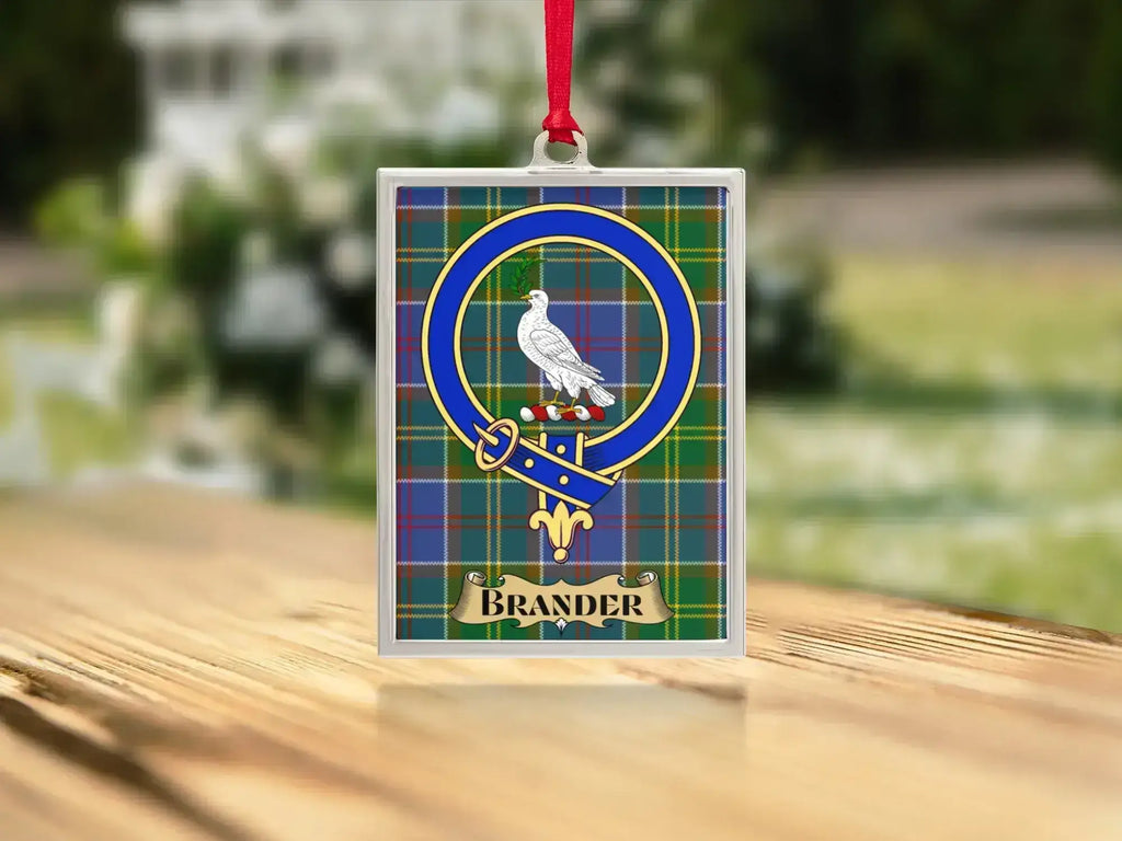 Close-up of the Brander family crest on a polished silver-frame metal ornament