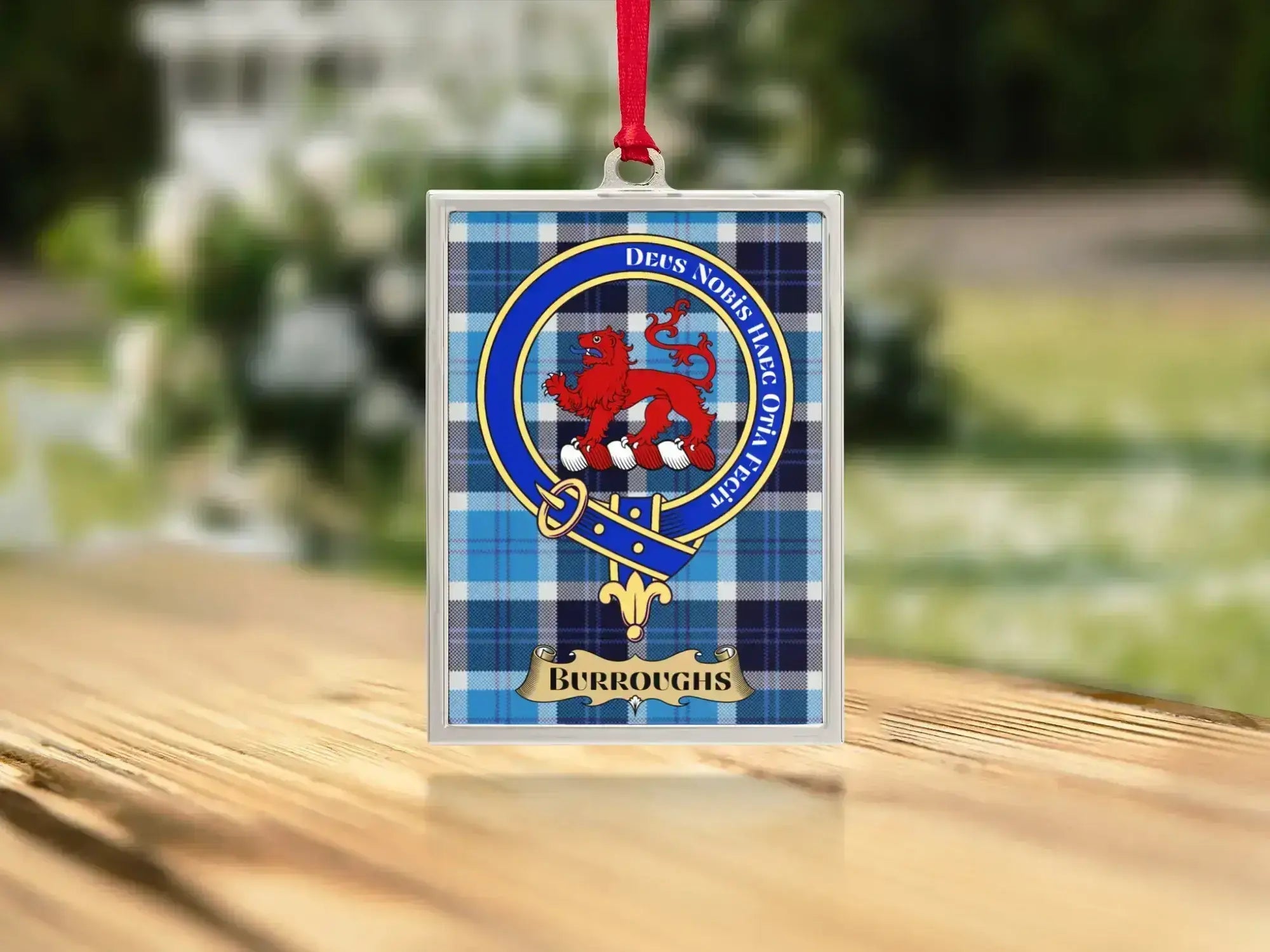Close-up of the Burroughs family crest on a polished silver-frame metal ornament