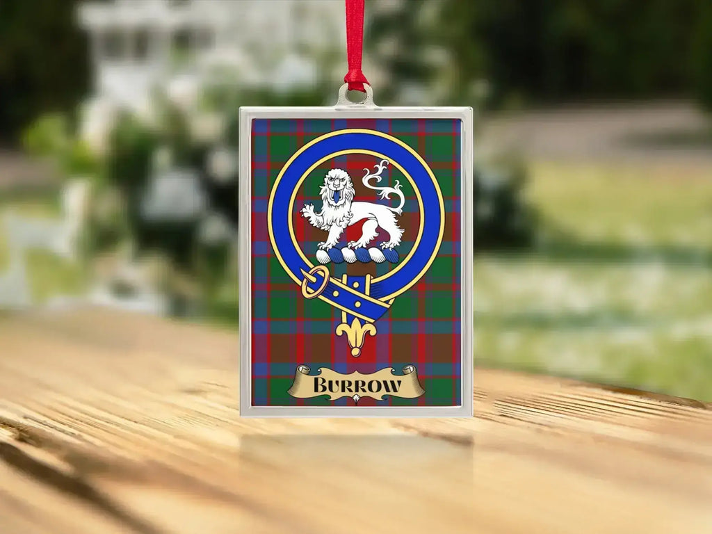 Close-up of the Burrow family crest on a polished silver-frame metal ornament