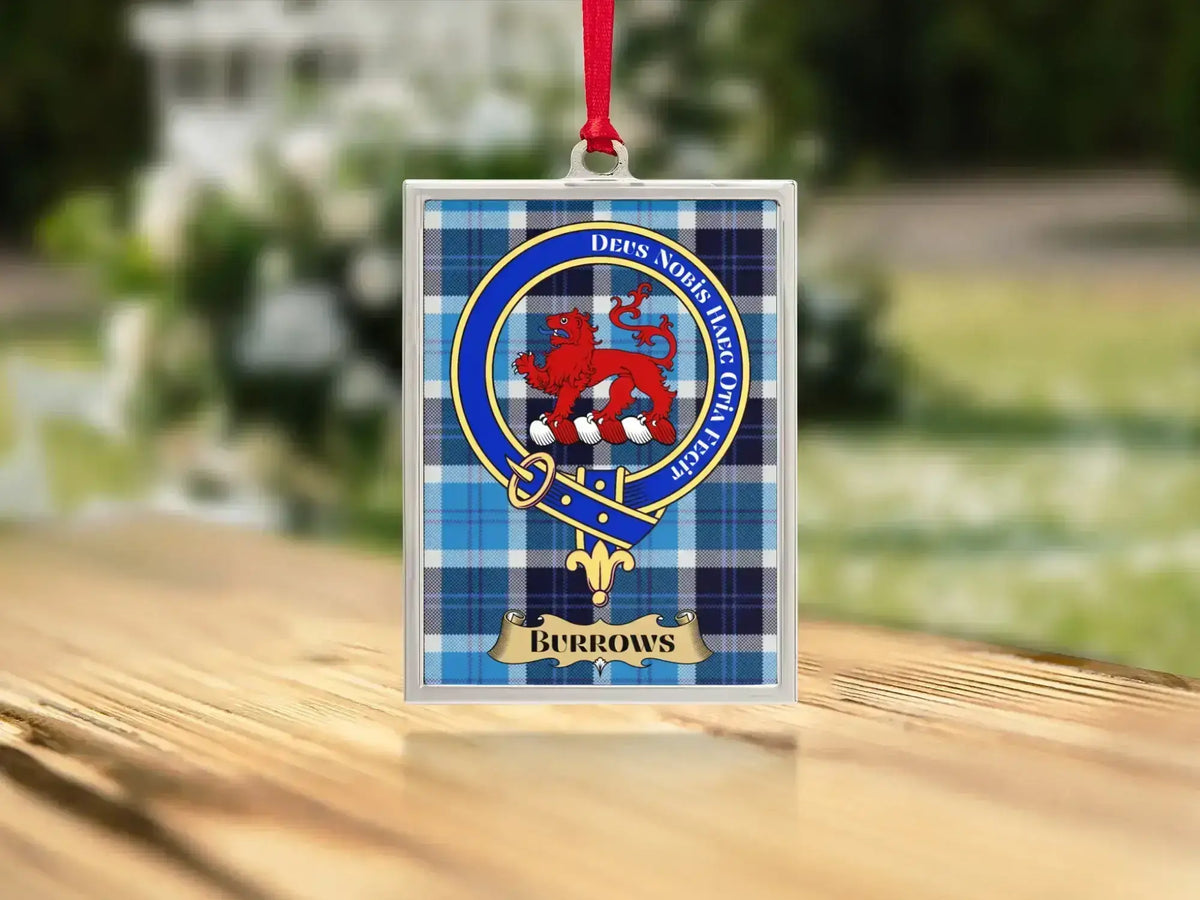 Close-up of the Burrows family crest on a polished silver-frame metal ornament