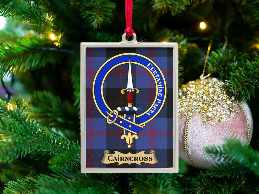 Cairncross clan crest Christmas ornament in a silver frame on a tartan background