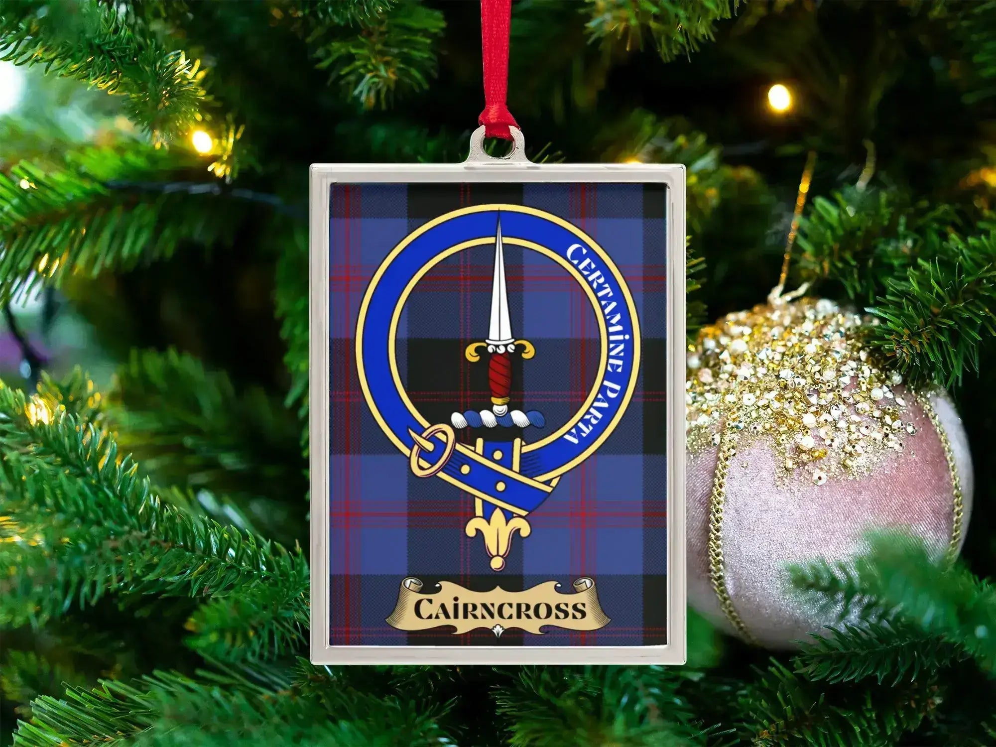 Cairncross clan crest Christmas ornament in a silver frame on a tartan background