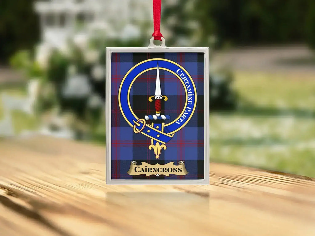 Close-up of the Cairncross family crest on a polished silver-frame metal ornament