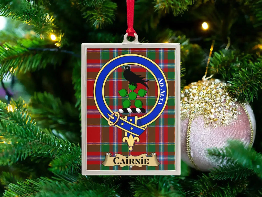 Cairnie clan crest Christmas ornament in a silver frame on a tartan background