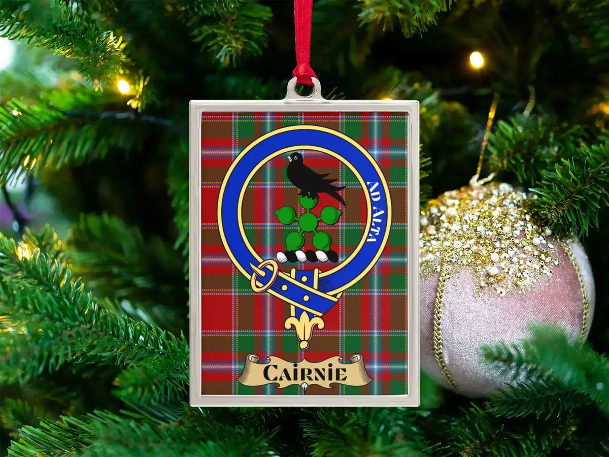 Cairnie clan crest Christmas ornament in a silver frame on a tartan background