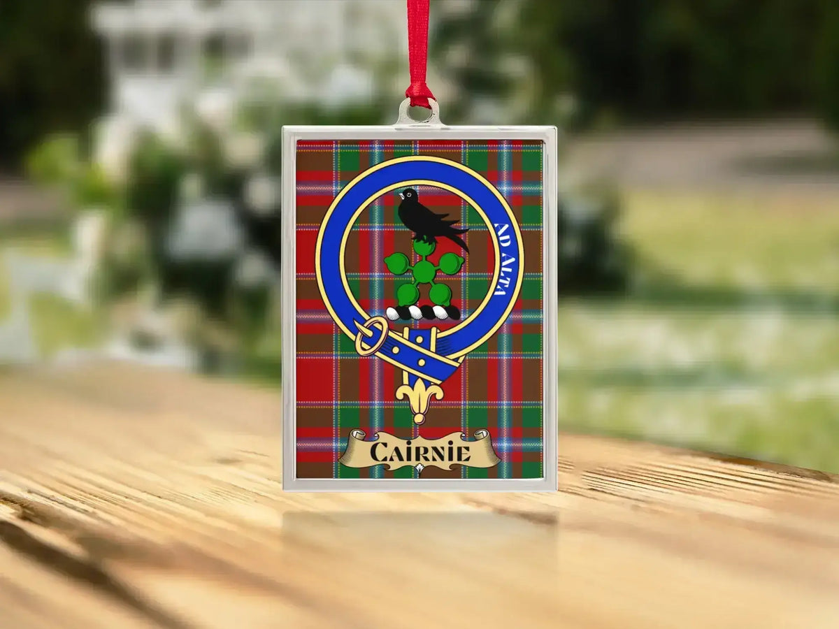 Close-up of the Cairnie family crest on a polished silver-frame metal ornament