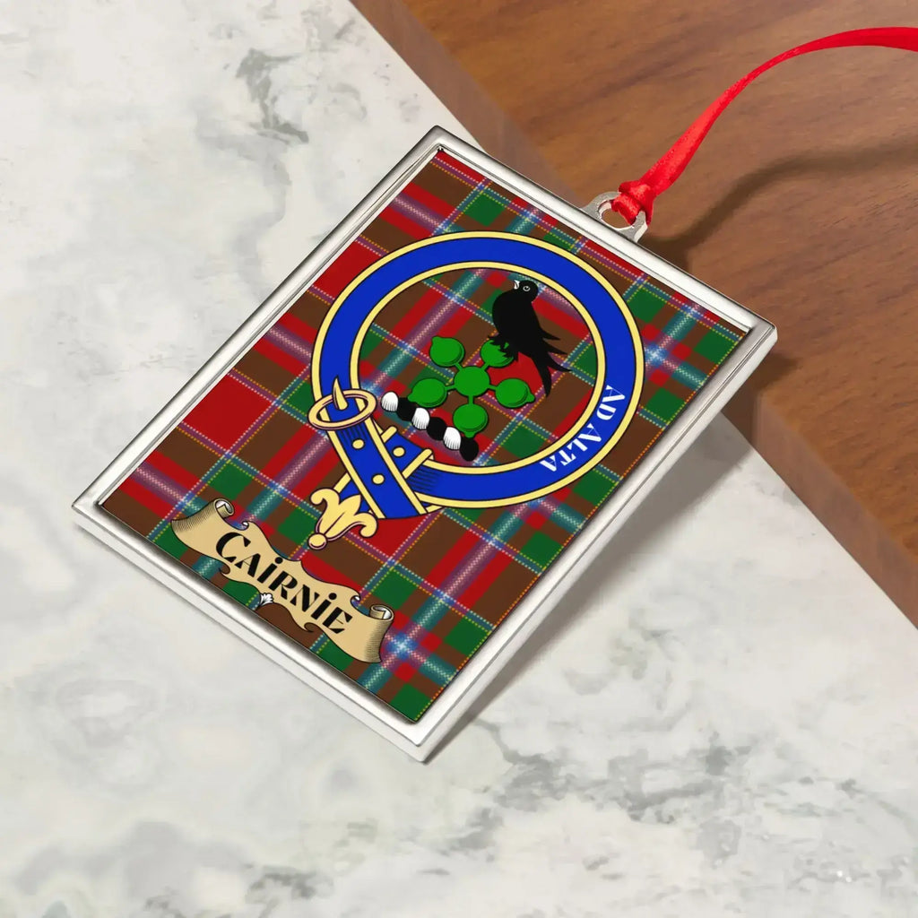 Cairnie ornament hanging from a Christmas tree branch by its satin ribbon