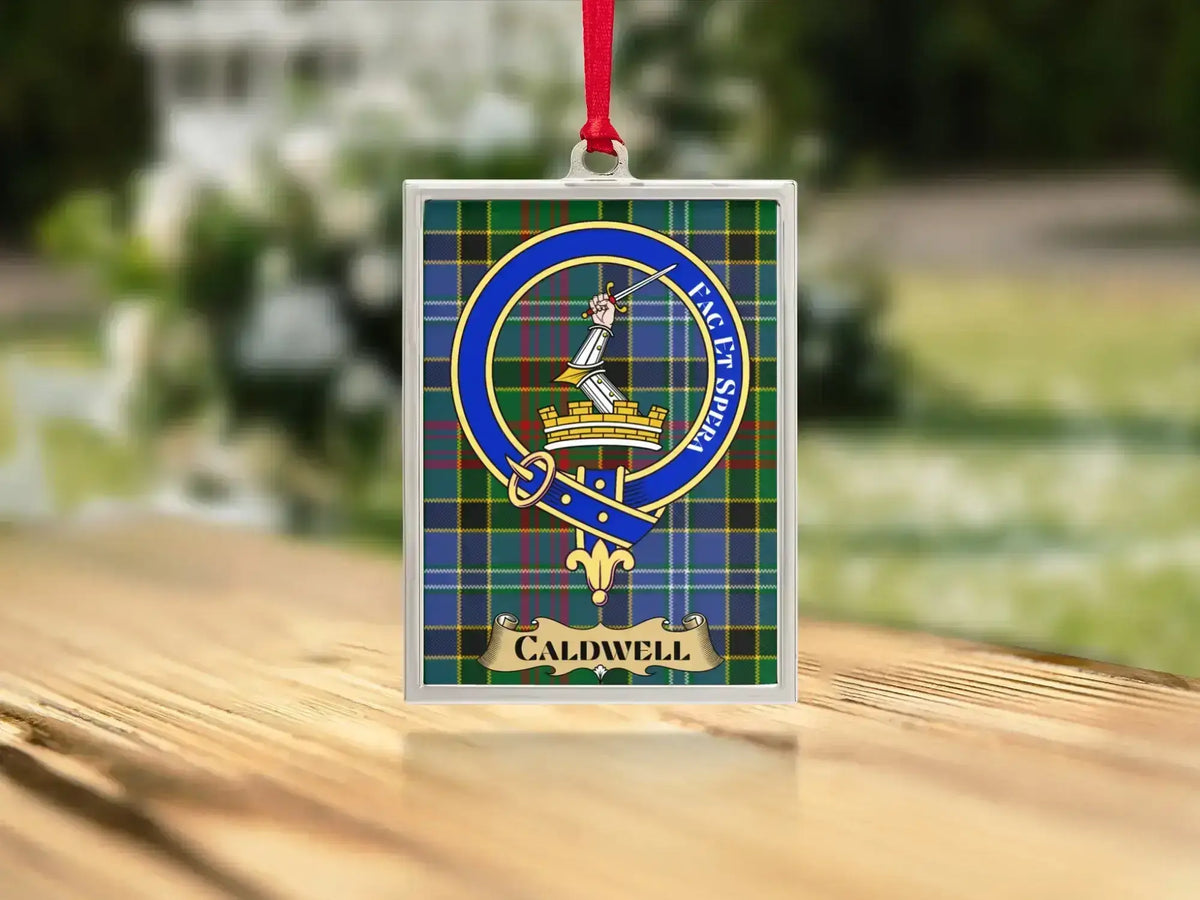 Close-up of the Caldwell family crest on a polished silver-frame metal ornament