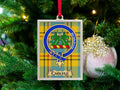 Carlyle clan crest Christmas ornament in a silver frame on a tartan background