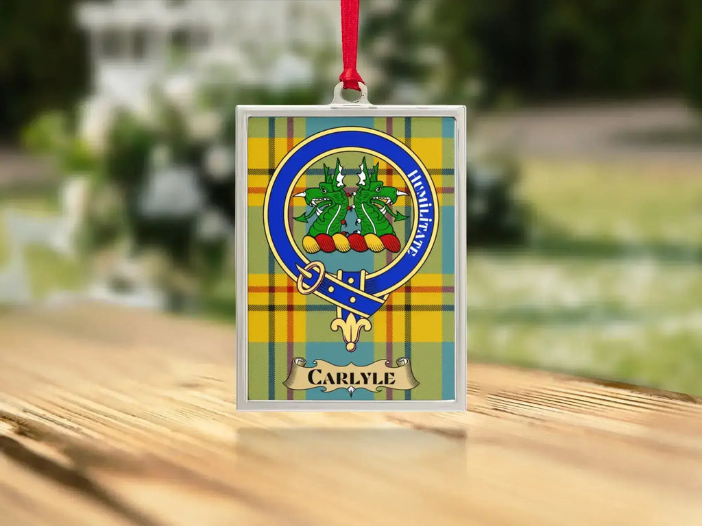 Close-up of the Carlyle family crest on a polished silver-frame metal ornament