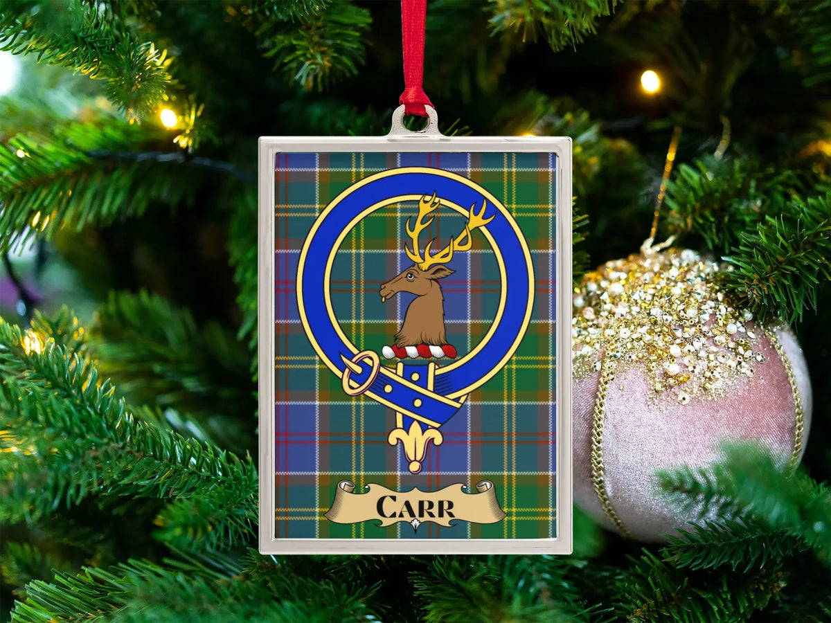 Carr clan crest Christmas ornament in a silver frame on a tartan background
