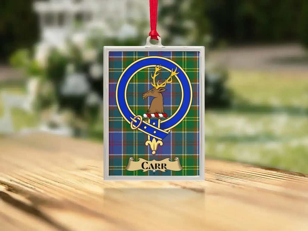Close-up of the Carr family crest on a polished silver-frame metal ornament