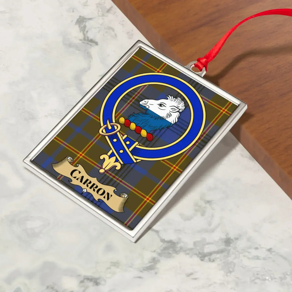 Carron ornament hanging from a Christmas tree branch by its satin ribbon
