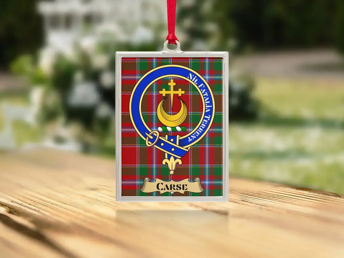 Close-up of the Carse family crest on a polished silver-frame metal ornament
