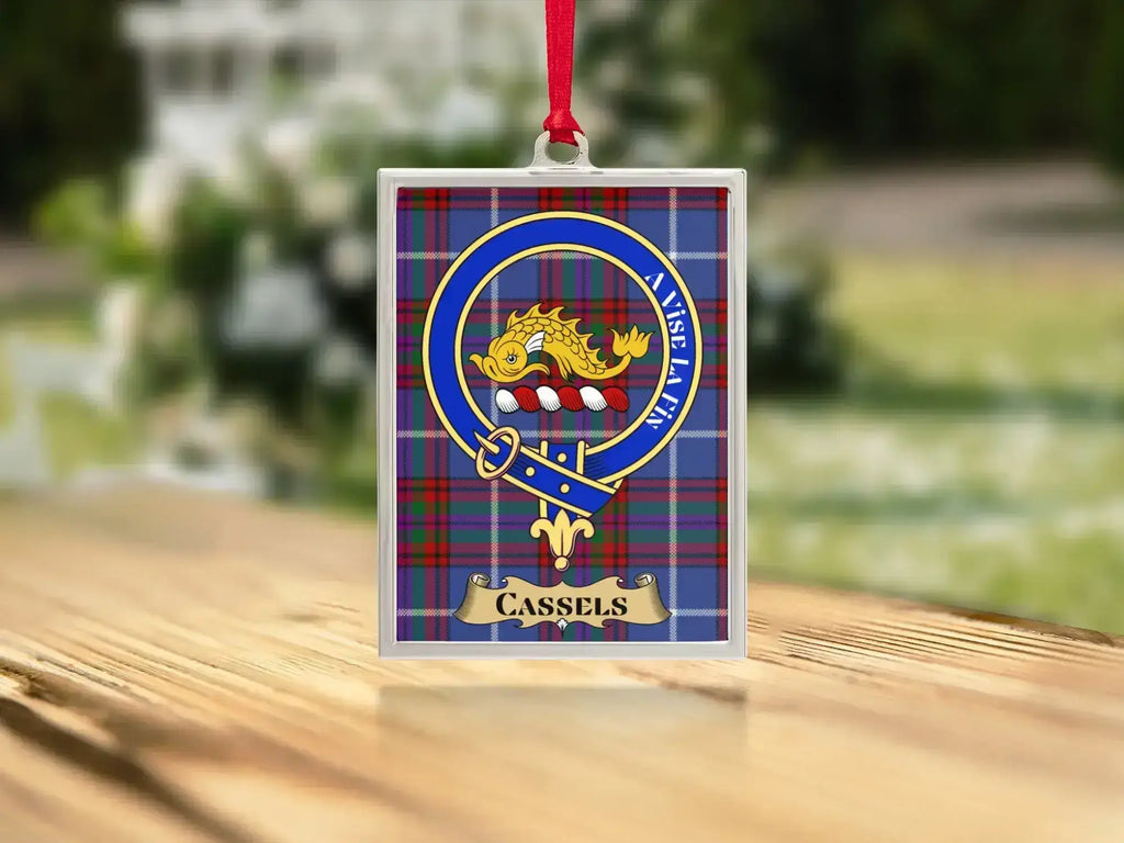 Close-up of the Cassels family crest on a polished silver-frame metal ornament