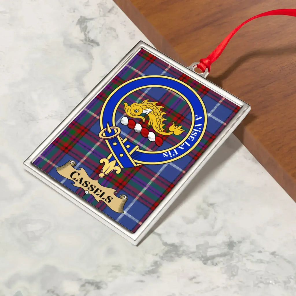 Cassels ornament hanging from a Christmas tree branch by its satin ribbon