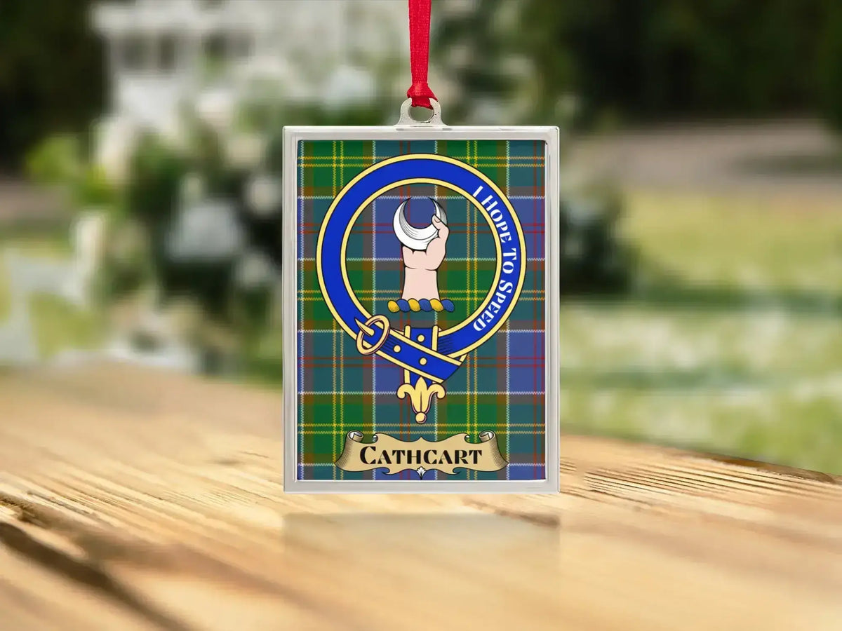 Close-up of the Cathcart family crest on a polished silver-frame metal ornament