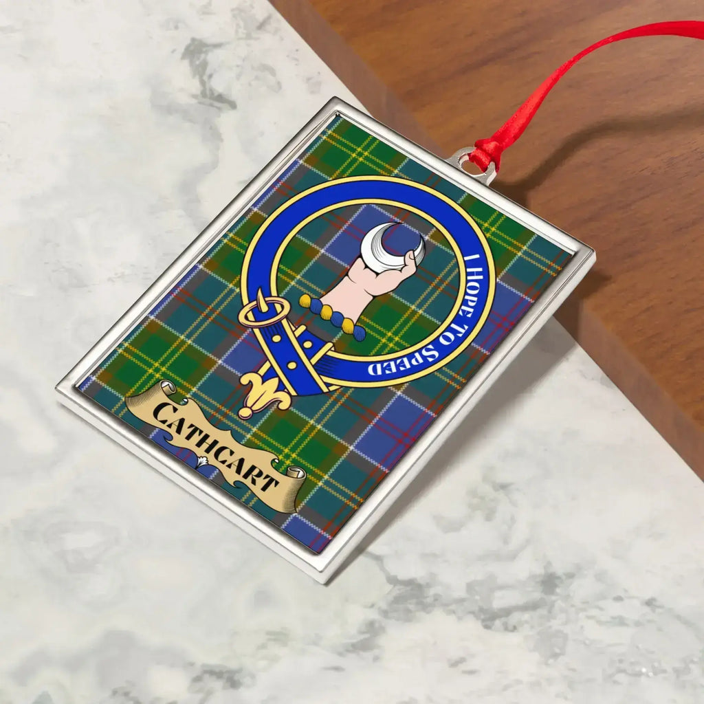 Cathcart ornament hanging from a Christmas tree branch by its satin ribbon