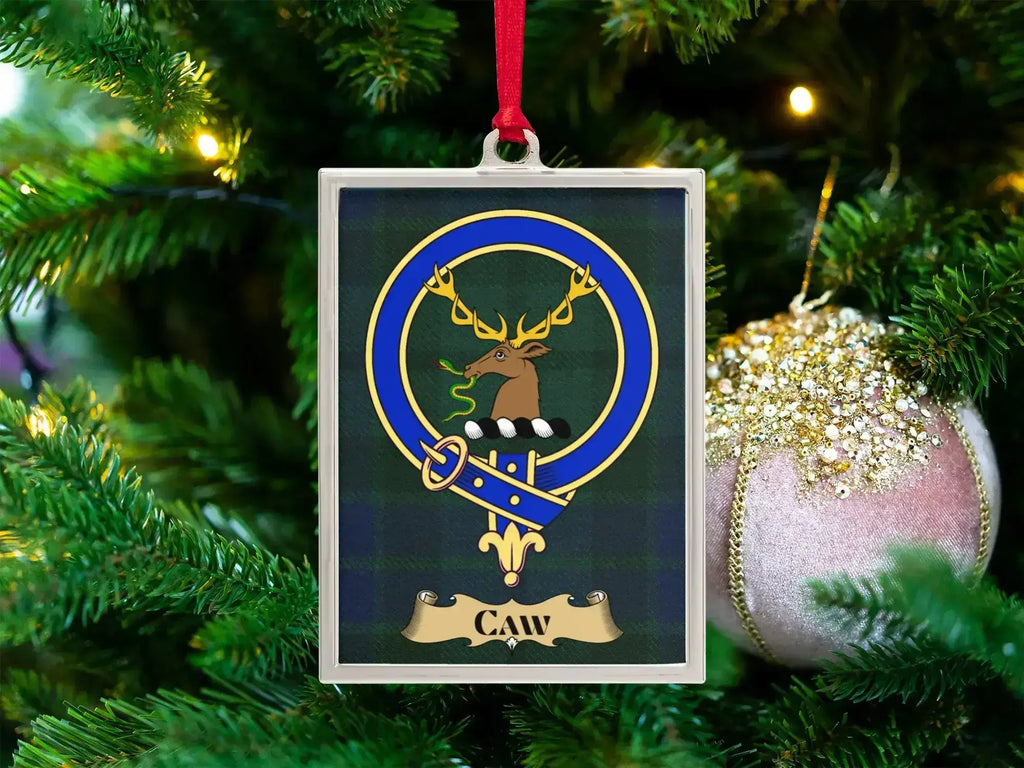 Caw clan crest Christmas ornament in a silver frame on a tartan background