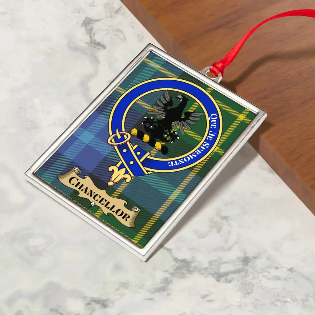 Chancellor ornament hanging from a Christmas tree branch by its satin ribbon