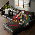 Chisholm clan crest tartan throw blanket on sofa — 50x60 polyester, green-red clan design