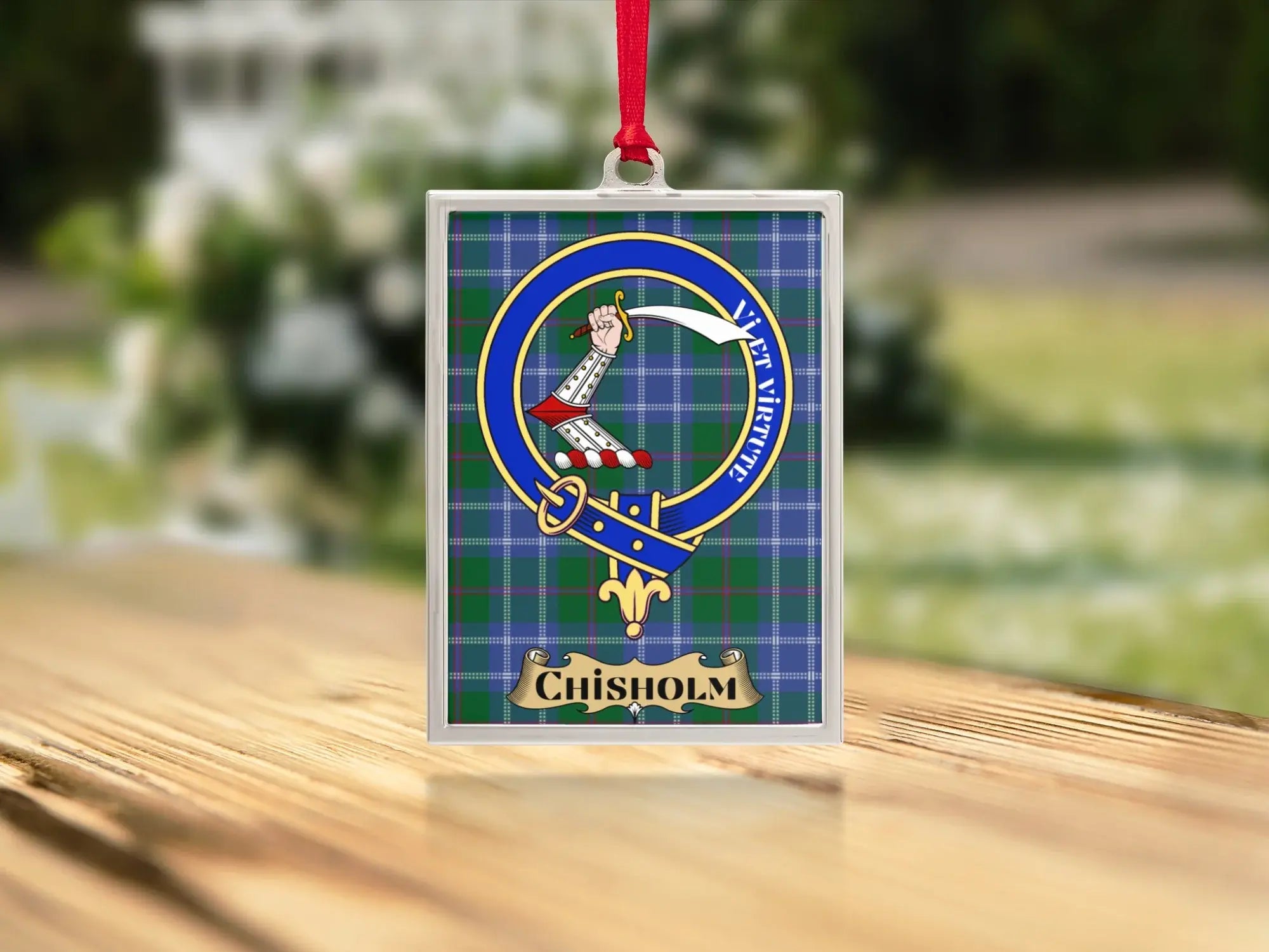 Chisholm clan tartan ornament design detail — green and red plaid with heraldic crest