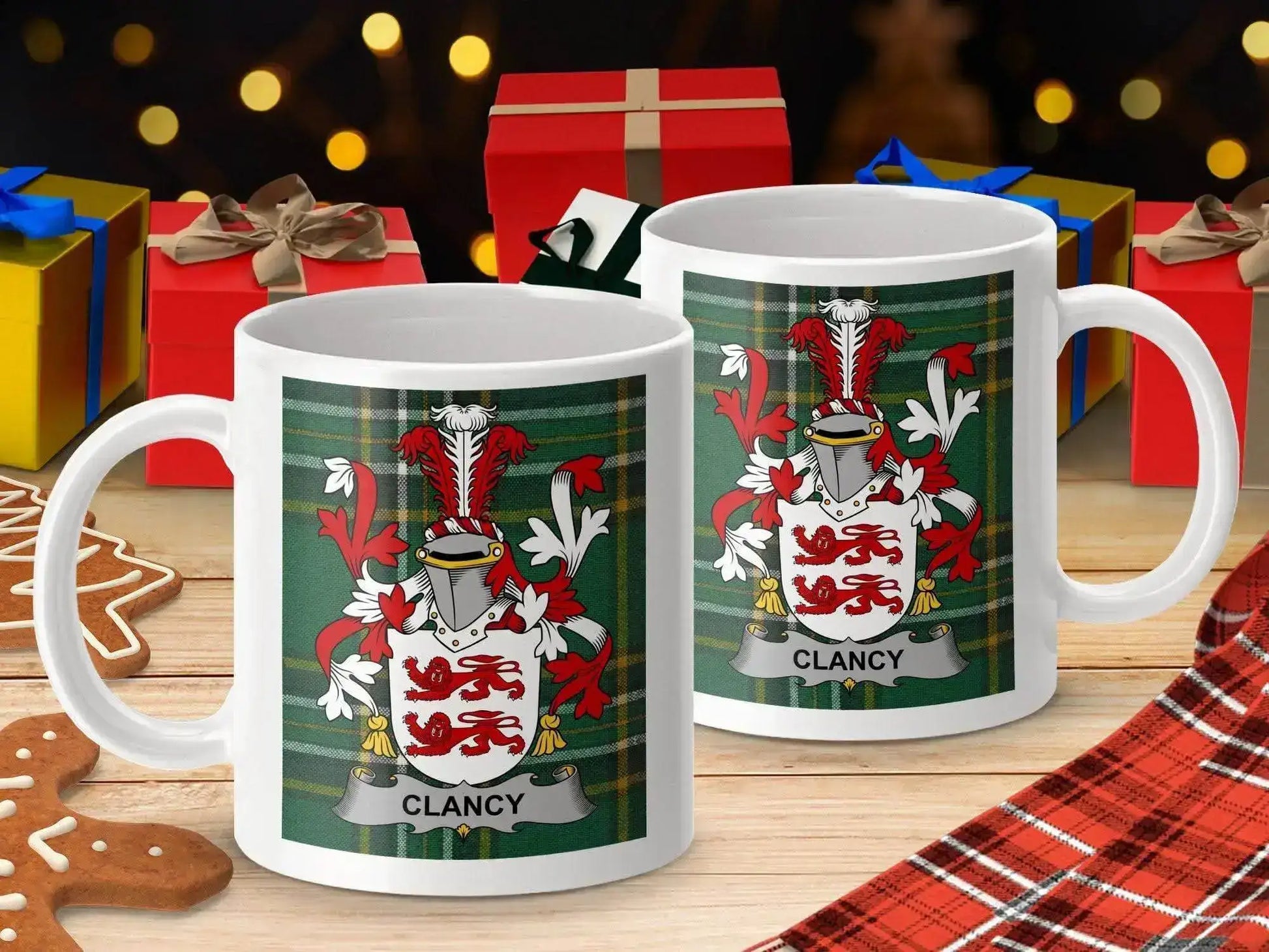 White mugs with Clancy family crest on green tartan, holiday gifts and gingerbread on wooden table